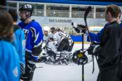 Eishockeyspieler versammeln sich auf dem Eis zu einer Besprechung in der 100’s Arena.