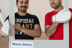 Zwei Personen halten einen großen #BEACTIVE-Rahmen; darunter steht „Move more, feel better.“